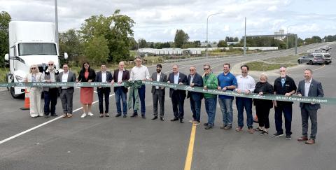 Local and state leaders pose for a photo during a ceremonial ribbon cutting on Friday, September 11, 2026, before the opening of the first section of the new State Route 167 Expressway in Pierce County.
