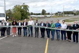 Local and state leaders pose for a photo during a ceremonial ribbon cutting on Friday, September 11, 2026, before the opening of the first section of the new State Route 167 Expressway in Pierce County.